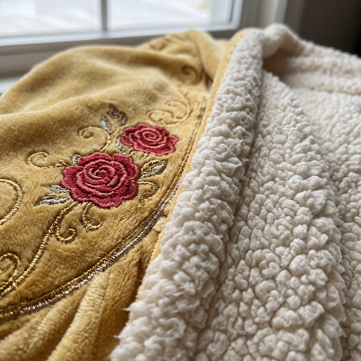 Close-up of rose embroidery and sherpa lining